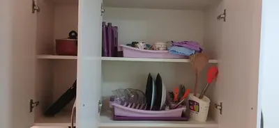 a white cabinet filled with lots of utensils at Florenza Khamsin Hurghada in Hurghada