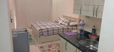 a small kitchen with a bed and a sink at Florenza Khamsin Hurghada in Hurghada