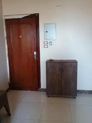 a room with a wooden door and a cabinet at Families only in Al ‘Izbah wa al ‘Arab