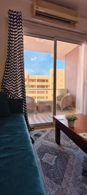 a living room with a couch and a large window at Florenza in Hurghada