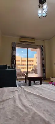 a bedroom with a bed and a couch and a window at Florenza in Hurghada