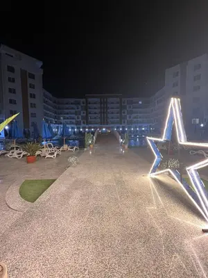 a large star decoration on the side of a building at night at Tiba Gold in Hurghada