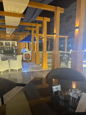 a view of a building with a table and chairs at Tiba Gold in Hurghada