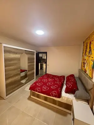 a bedroom with a large red bed in it at Tiba Gold in Hurghada