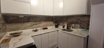 a kitchen with white cabinets and a sink at Mountain house in ‘Ezbet Abu Ḥabashi
