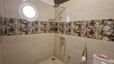 a bathroom with a shower and a toilet at Mountain house in ‘Ezbet Abu Ḥabashi