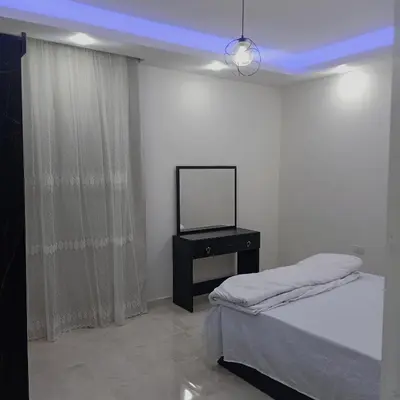 a room with a bed and a television on a table at Selena bay resort in Hurghada