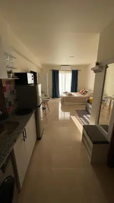 a room with a kitchen and a living room at Luxury studio with beach in Hurghada