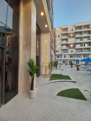a building with a potted plant in the middle of a courtyard at Luxury studio with beach in Hurghada