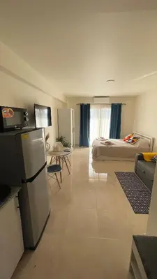 a room with a kitchen and a bedroom with a bed at Luxury studio with beach in Hurghada