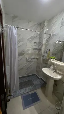 a bathroom with a shower and a sink at Luxury studio with beach in Hurghada