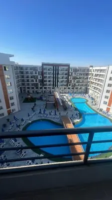 a view of a large apartment complex with a swimming pool at Luxury studio with beach in Hurghada