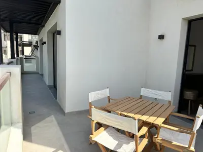 a wooden table and chairs in a room at Fanadir Marina Vista in Hurghada