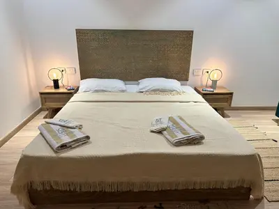 a bedroom with a large bed with two towels on it at Fanadir Marina Vista in Hurghada