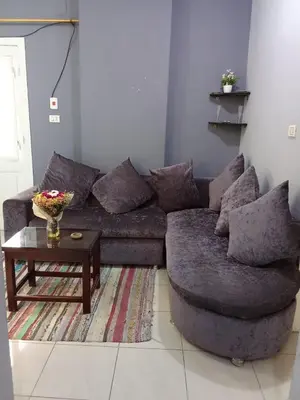 a living room with a couch and a coffee table at شقه الزناتى مطله على النيل in Luxor