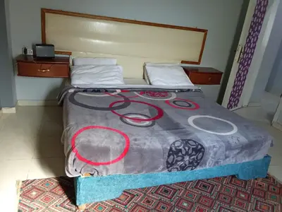 a bed in a room with a large bedspread at شقه الزناتى مطله على النيل in Luxor