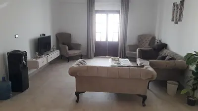 a living room with a couch and a tv at الاقصر البر الغربي امام معبد هابو in Al Aqālitah