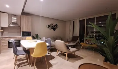 a kitchen and living room with a table and chairs at Stylish Gouna Mangroovy Retreat in Hurghada