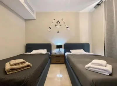 a bedroom with two beds with towels on them at Stylish Gouna Mangroovy Retreat in Hurghada