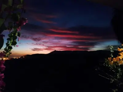 a sunset in the mountains with a red at Gabawy Garden in ‘Ezbet Abu Ḥabashi