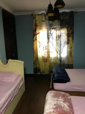 a room with two beds and a painting on the wall at cozy penthouse in New Cairo in Kharga