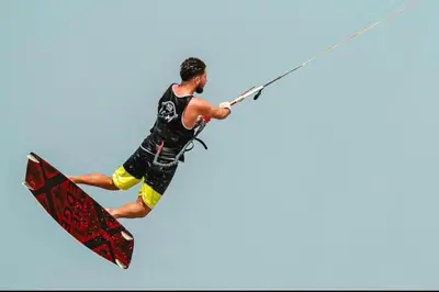 a man on a surfboard holding onto a rope at Selena bay resort in Hurghada
