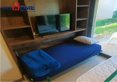 a room with a tv and a blue cushion at Cozy Studio 1BR G Cribs b19-g7 El-Gouna Shared Heatd Pool in El Gouna