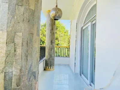 a hallway with two columns and a balcony at Villa Luna Simone in Al Karnak