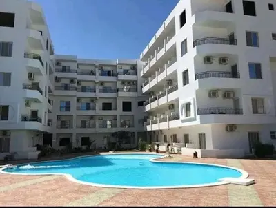 a large apartment building with a large swimming pool at Hurghada European style in Hurghada