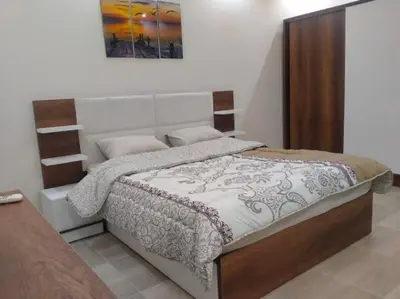 a bedroom with a large bed with a wooden headboard at Hurghada European style in Hurghada