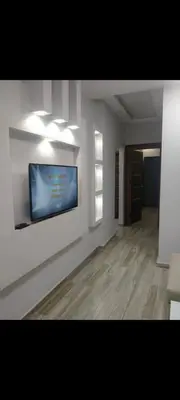 a living room with a flat screen tv on a wall at Hurghada European style in Hurghada