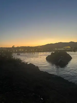 a view of a body of water at sunset at Nubia House Nile View in Nag` el-Ramla