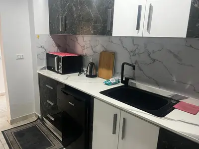a kitchen counter with a sink and a microwave at Scandic sea view in Hurghada