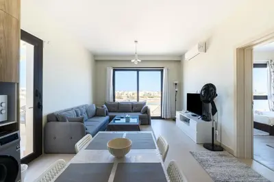 a living room with a couch and a table at Brand New Shedwan Spacious 1Bdr in Hurghada