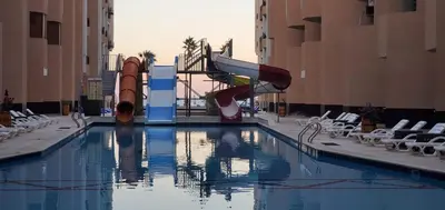 a swimming pool with a slide in a resort at Seaview 2 Bedroom Private Deluxe Condo at Juliana Beach Resort B2-09 in Hurghada