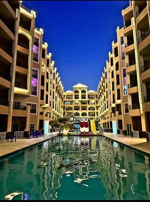 a swimming pool in the middle of a building at Seaview 2 Bedroom Private Deluxe Condo at Juliana Beach Resort B2-09 in Hurghada