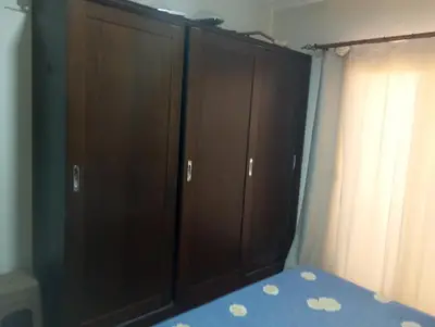 a bedroom with brown cabinets and a blue bed at Casablanca Resort A F in Hurghada