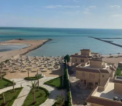 an aerial view of a beach with umbrellas and the ocean at Casablanca Resort A F in Hurghada