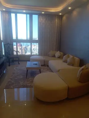 a living room with a couch and a table at شقه على النيل in Luxor