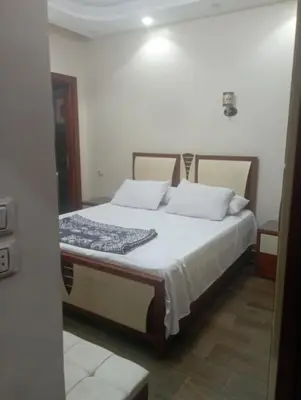 a bedroom with a bed with white sheets and pillows at شقه على النيل in Luxor