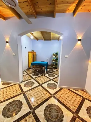 a room with a table and a tiled floor at Ammar Guest House in Luxor