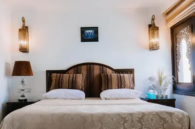 a bedroom with a large bed with two pillows at Saphir Dahabiya luxury sailing boat Nile cruise Every Saturday from Luxor 4 or 7 nights in Luxor