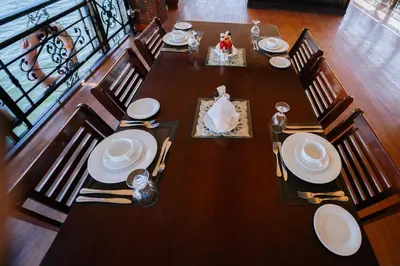 a wooden table with chairs and plates on it at Saphir Dahabiya luxury sailing boat Nile cruise Every Saturday from Luxor 4 or 7 nights in Luxor