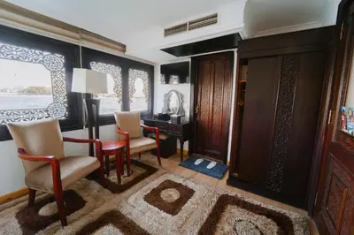 a living room with a desk and chairs at Saphir Dahabiya luxury sailing boat Nile cruise Every Saturday from Luxor 4 or 7 nights in Luxor