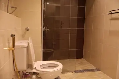 a bathroom with a toilet and a shower at Cosy studio Florenza khamsin in hurghada in Hurghada