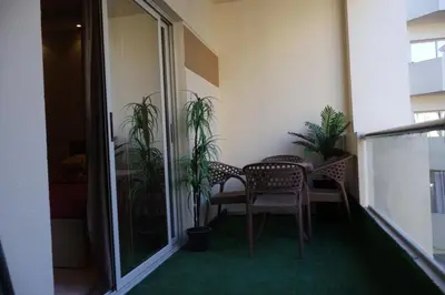 a balcony with a table and chairs and plants at Cosy studio Florenza khamsin in hurghada in Hurghada