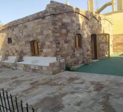 an outside view of a stone building at Old Nile Retreat in Luxor