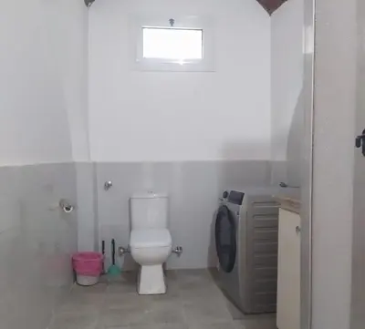 a bathroom with a toilet and a sink and a window at Old Nile Retreat in Luxor