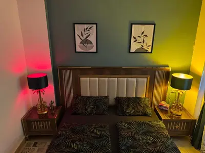 a bedroom with a bed and two lamps on tables at Modernes Komfort mit Smart TV & Power W-LAN, Strandnähe in Hurghada in Hurghada