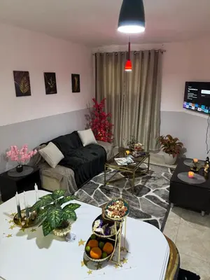 a living room with a couch and a table at Modernes Komfort mit Smart TV & Power W-LAN, Strandnähe in Hurghada in Hurghada